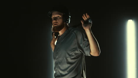 Caucasian-professional-baseball-player-batter-posing-against-dark-background